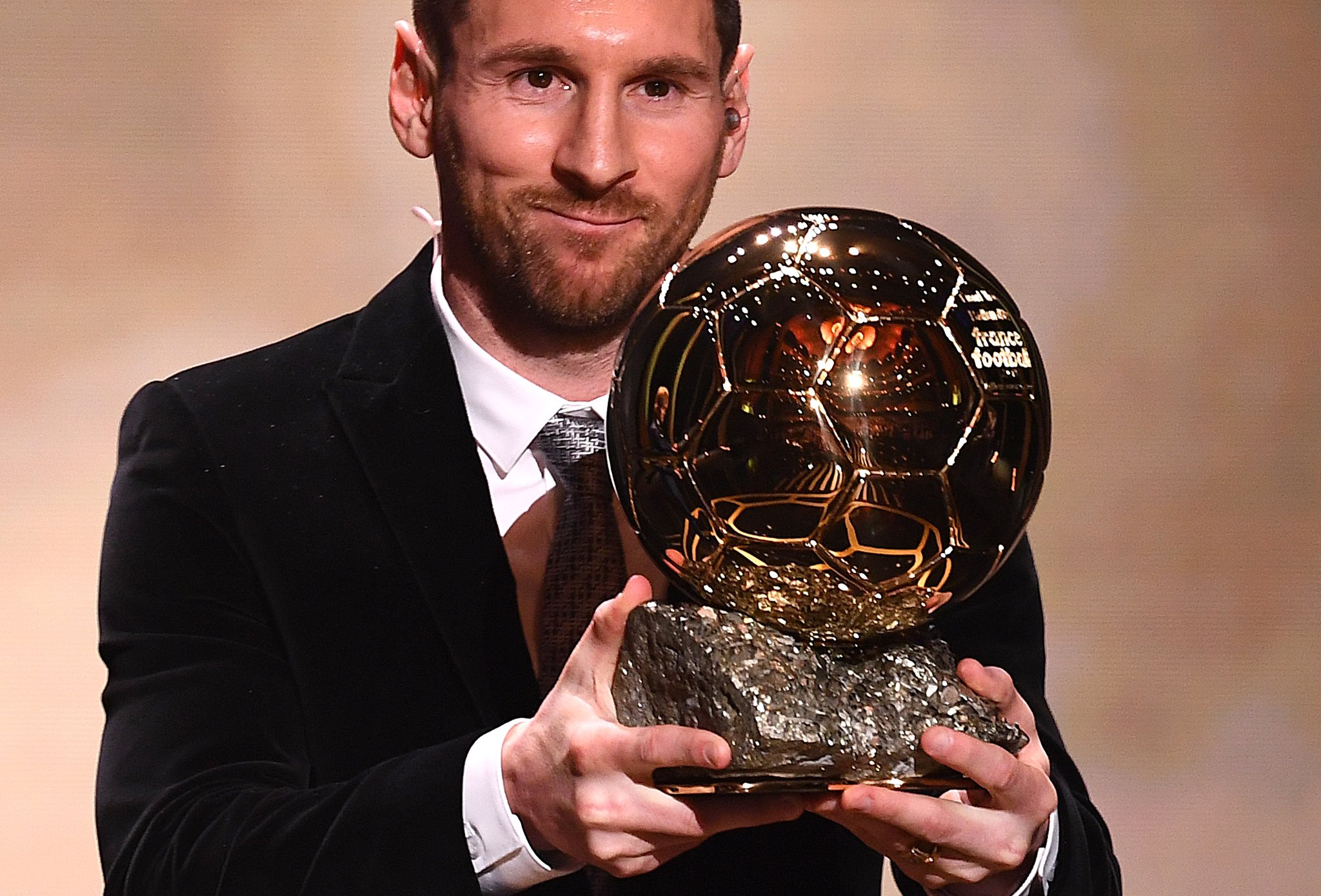 Lionel Messi holding the Ballon d'Or trophy
