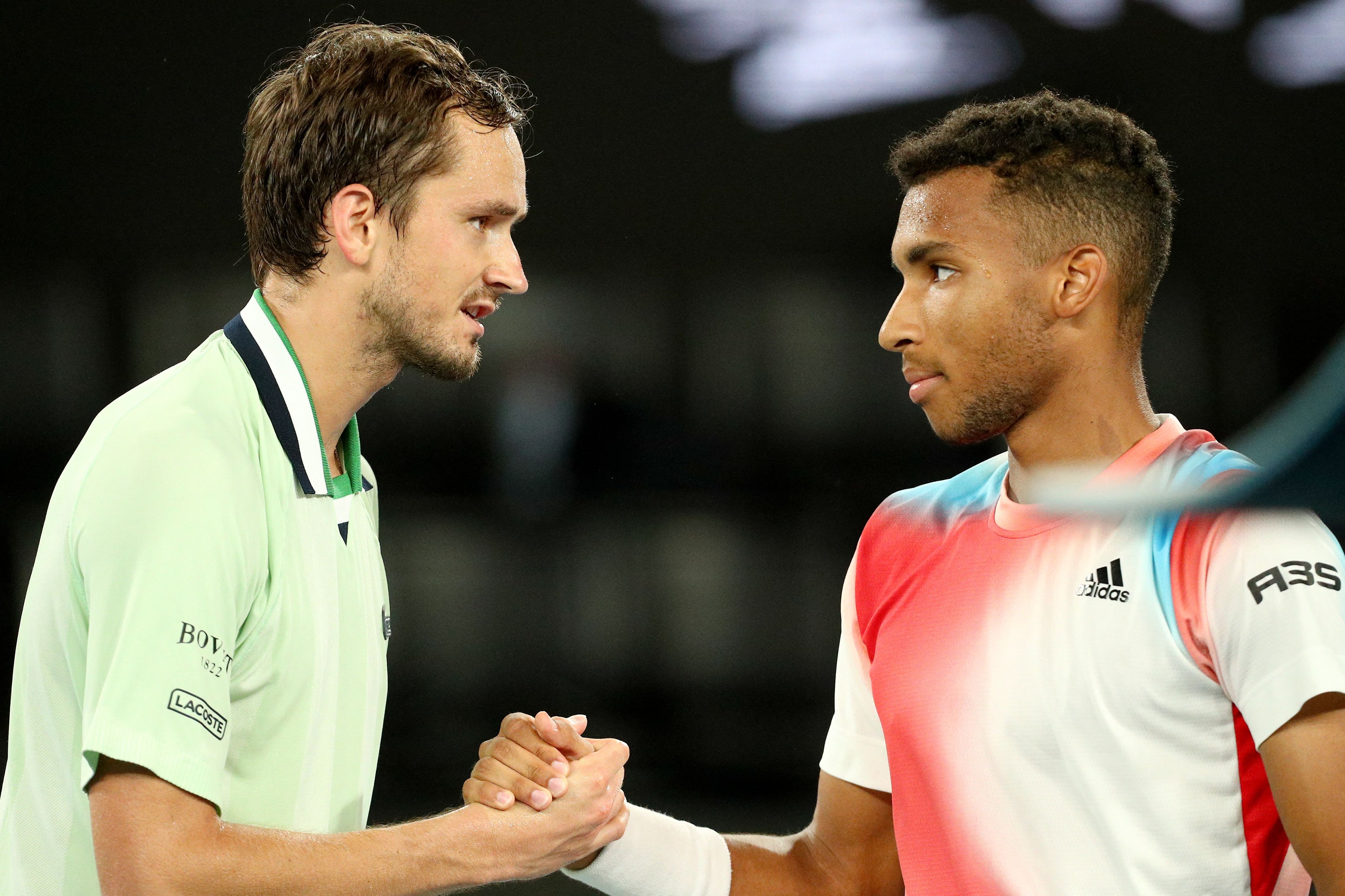 Medvedev and Aliasime shake hands after their 5-set thriiller at the 2022 Australian Open