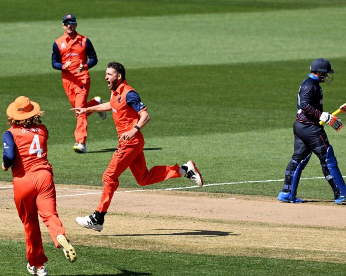 The Netherlands cricket team celebrate after taking a wicket in their ICC Men's T20 World Cup match against Scotland