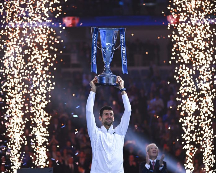 Novak Djokovic lifts the ATP Finals trophy after dominating in the tournament