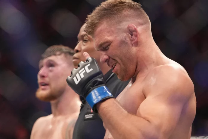 Dricus du Plessis in the cage reacting to his win over Darren Till at UFC 282.