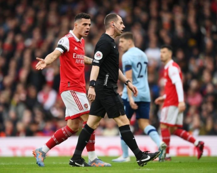 Arsenal's Granit Xhaka pleads offside to the referee.