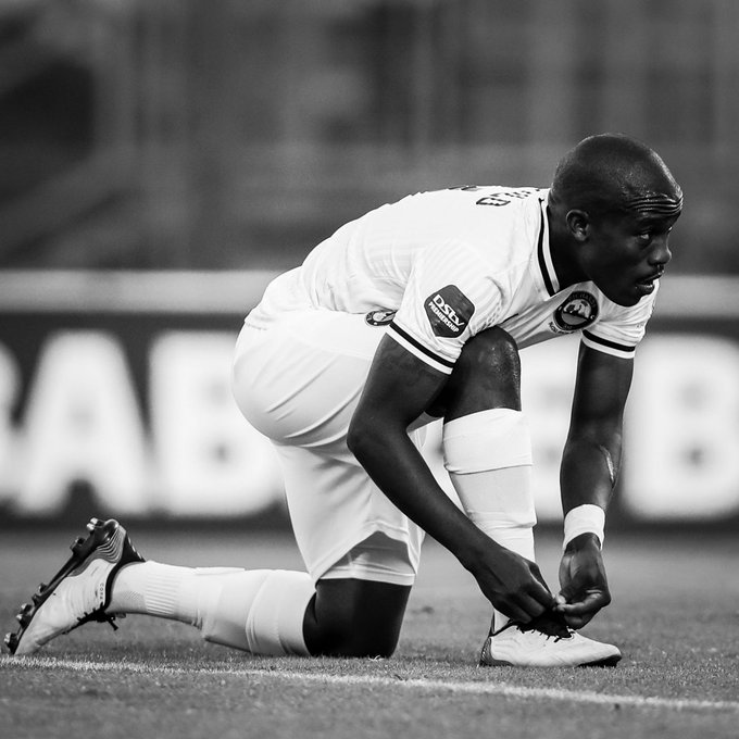 Siphamandla Mtolo ties his boots during a PSL match.