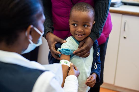 child receives vaccine from nurse