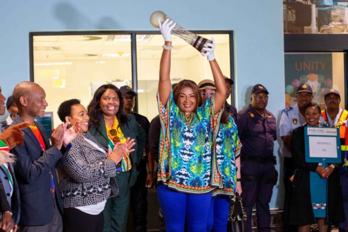 Netball trophy held high by woman