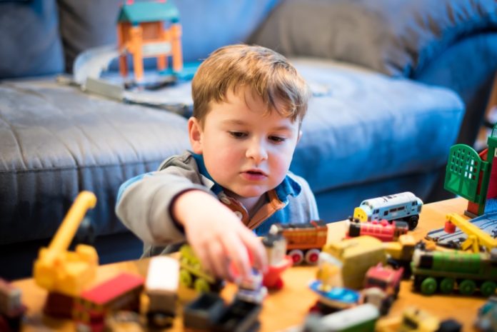 child playing with toys on the table