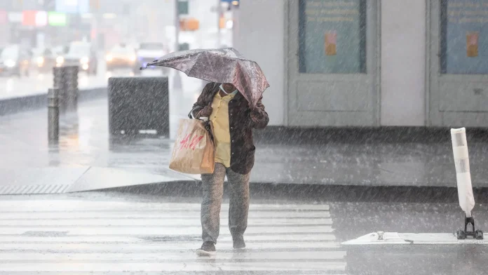 woman with umbrella walk through rain and thunderstorms