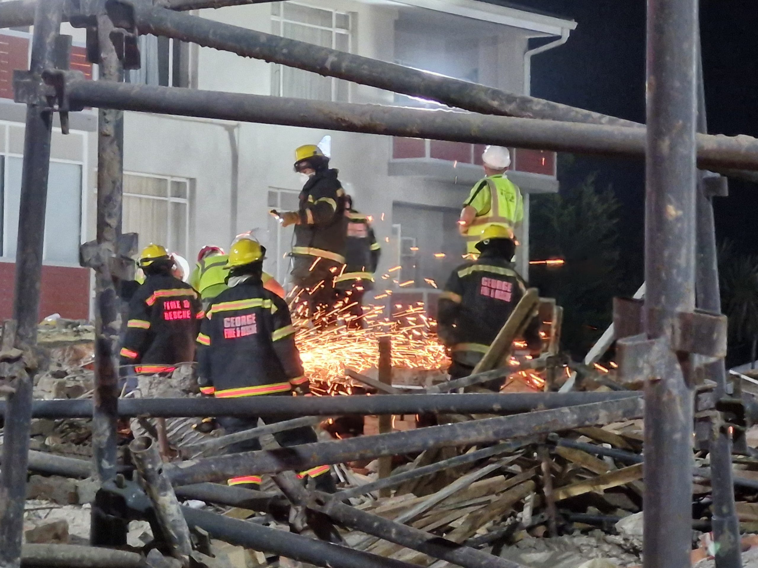 Rescue workers are urgently trying to retrieve scores of construction workers trapped under rubble of a collapsed building, that was under construction, in George.