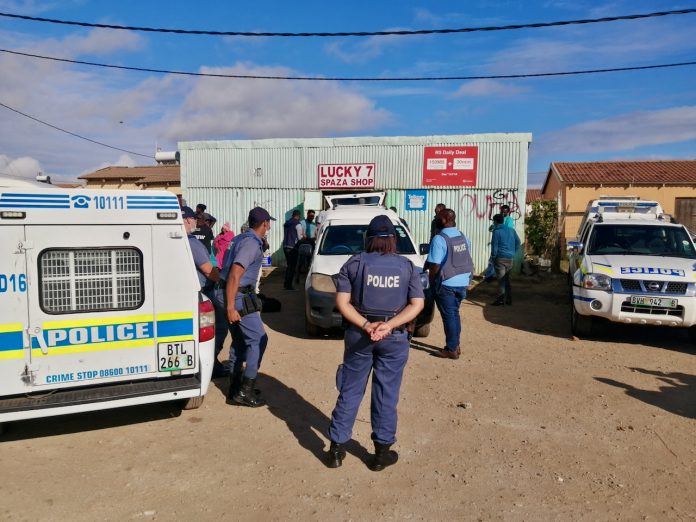 police protecting a spaza shop owner